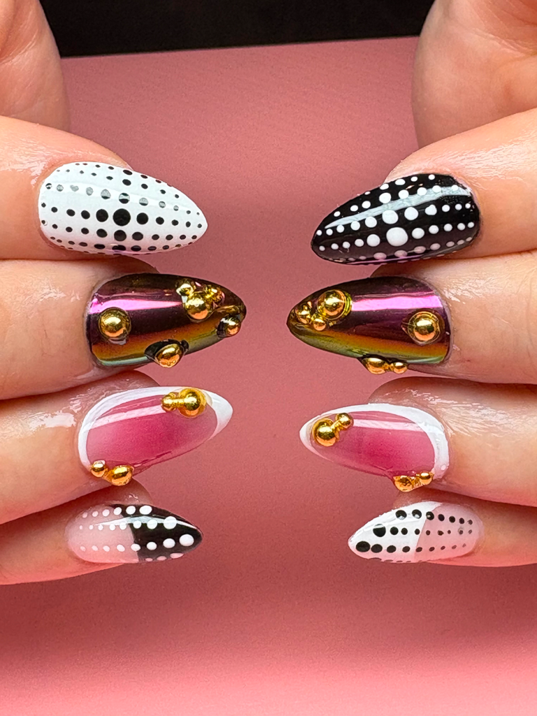 Pink black and white short almond Gel-X nails.