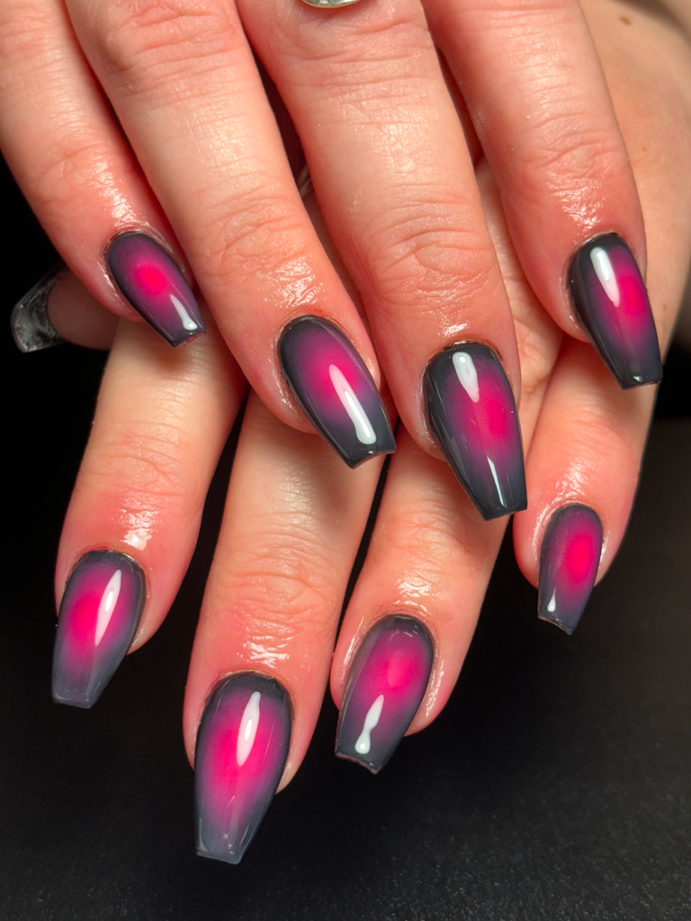 Neon pink aura on dark background Gel X nails.